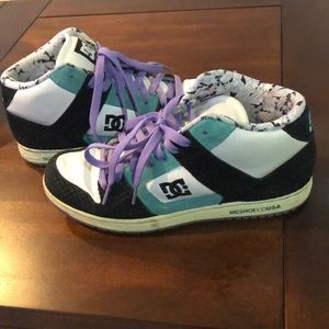 Black and teal DC sneakers with purple laces.